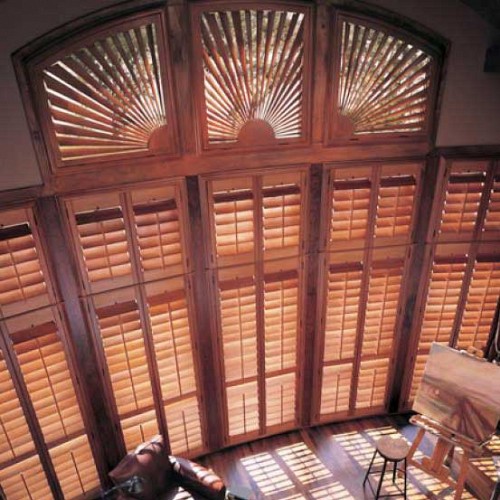 Dramatic sunburst arches with wood shutters