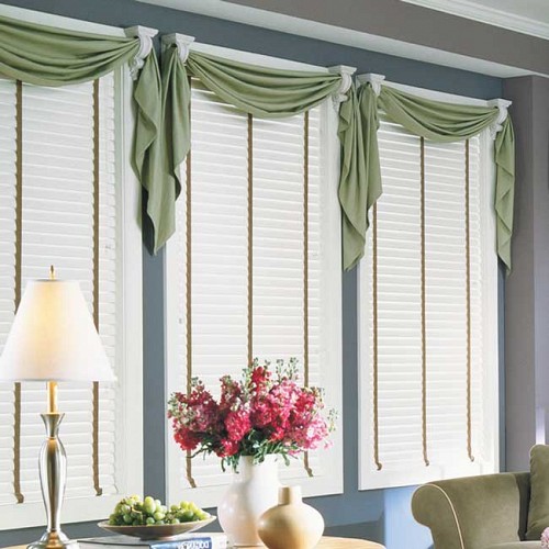 Fabric swags with decorative brackets