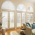 Wood shutters with matching sunburst arches